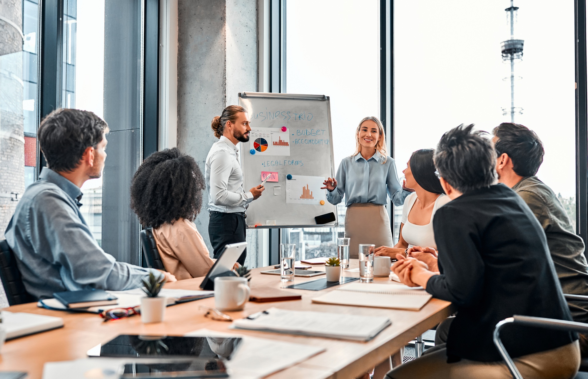 Two employees present their project to the team.