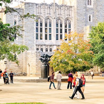 The University - College students walk around campus on a busy morning.